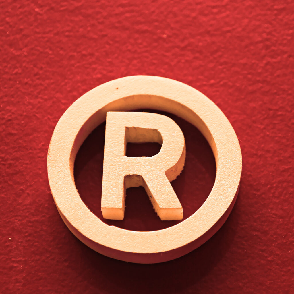 Registered trademark symbol on red background, used for Swift Law Insights article on Buc-ee’s trademark infringement lawsuit.